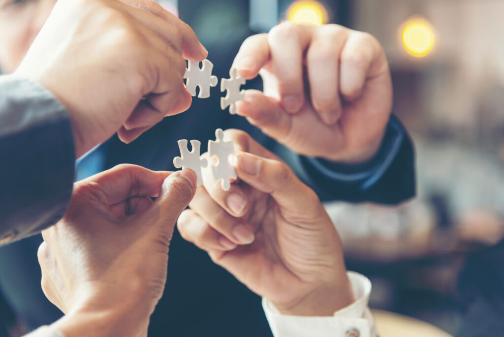 Businessman Team Work Holding Two Jigsaw Connecting Couple Puzzl